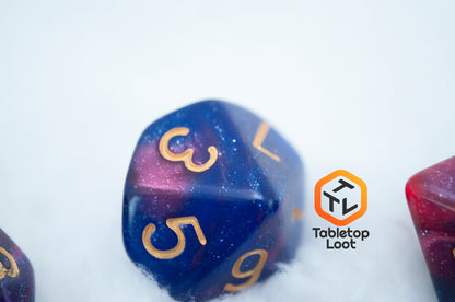 A close up of the D10 from the Rose Galaxy 7 piece dice set from Tabletop Loot with swirls of glittery pink, purple, and blue throughout with gold numbering.