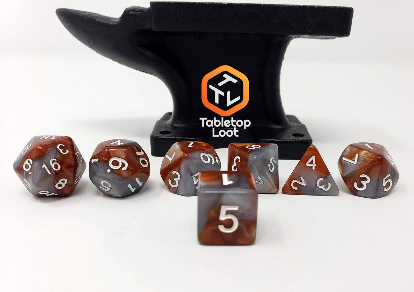 The Rusted Steel 7 piece dice set from Tabletop Loot with rust orange and silver swirls and white numbers.