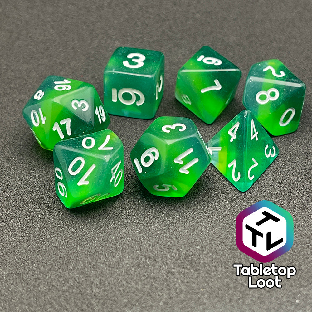 The Shillelagh 7 piece dice set from Tabletop Loot with layers of green to blue and white numbers.
