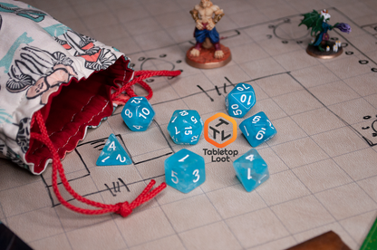 The Sky Blue 7 piece dice set from Tabletop Loot with blue and white swirls in clear resin and white numbering.