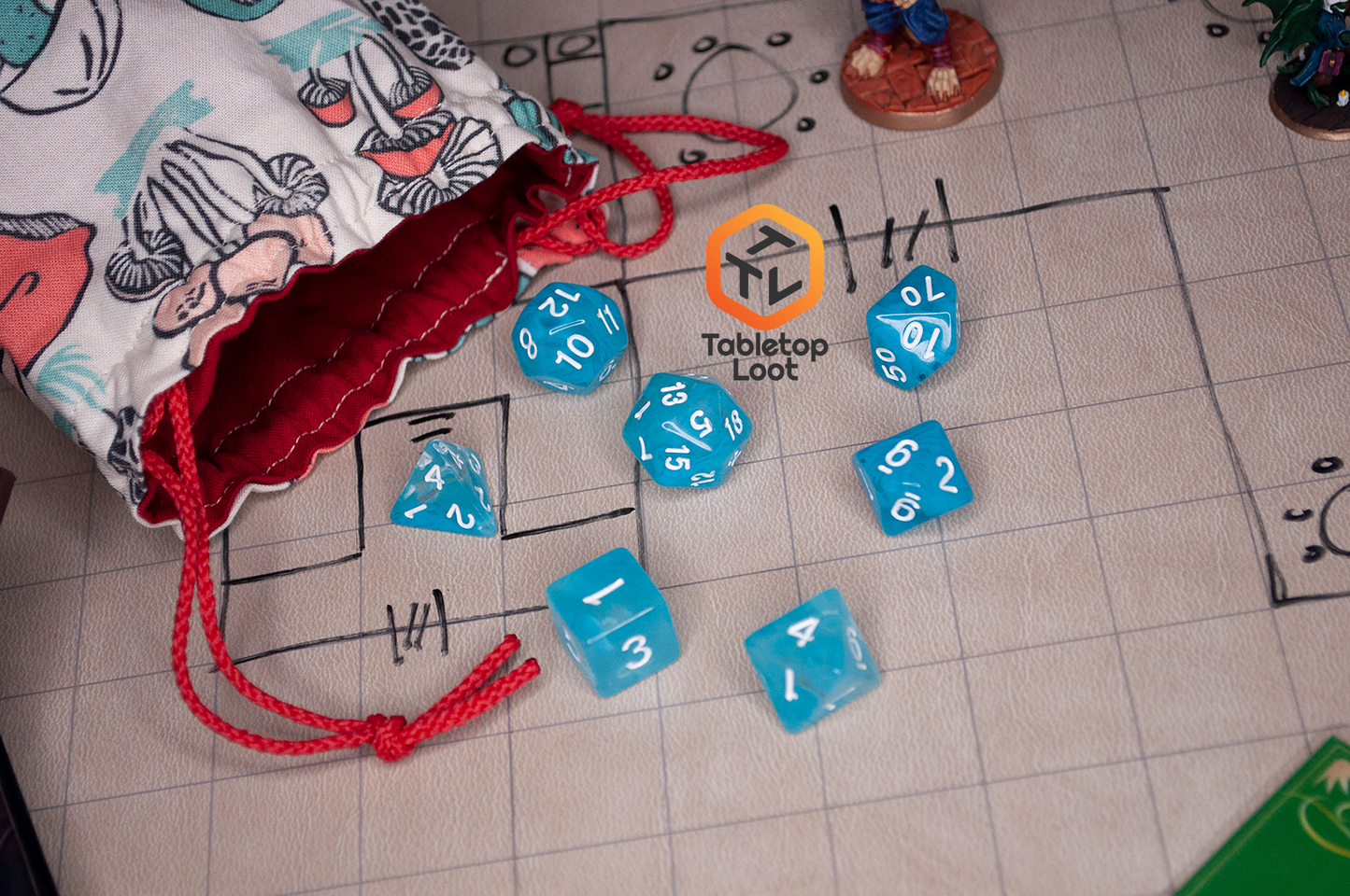 The Sky Blue 7 piece dice set from Tabletop Loot with blue and white swirls in clear resin and white numbering.