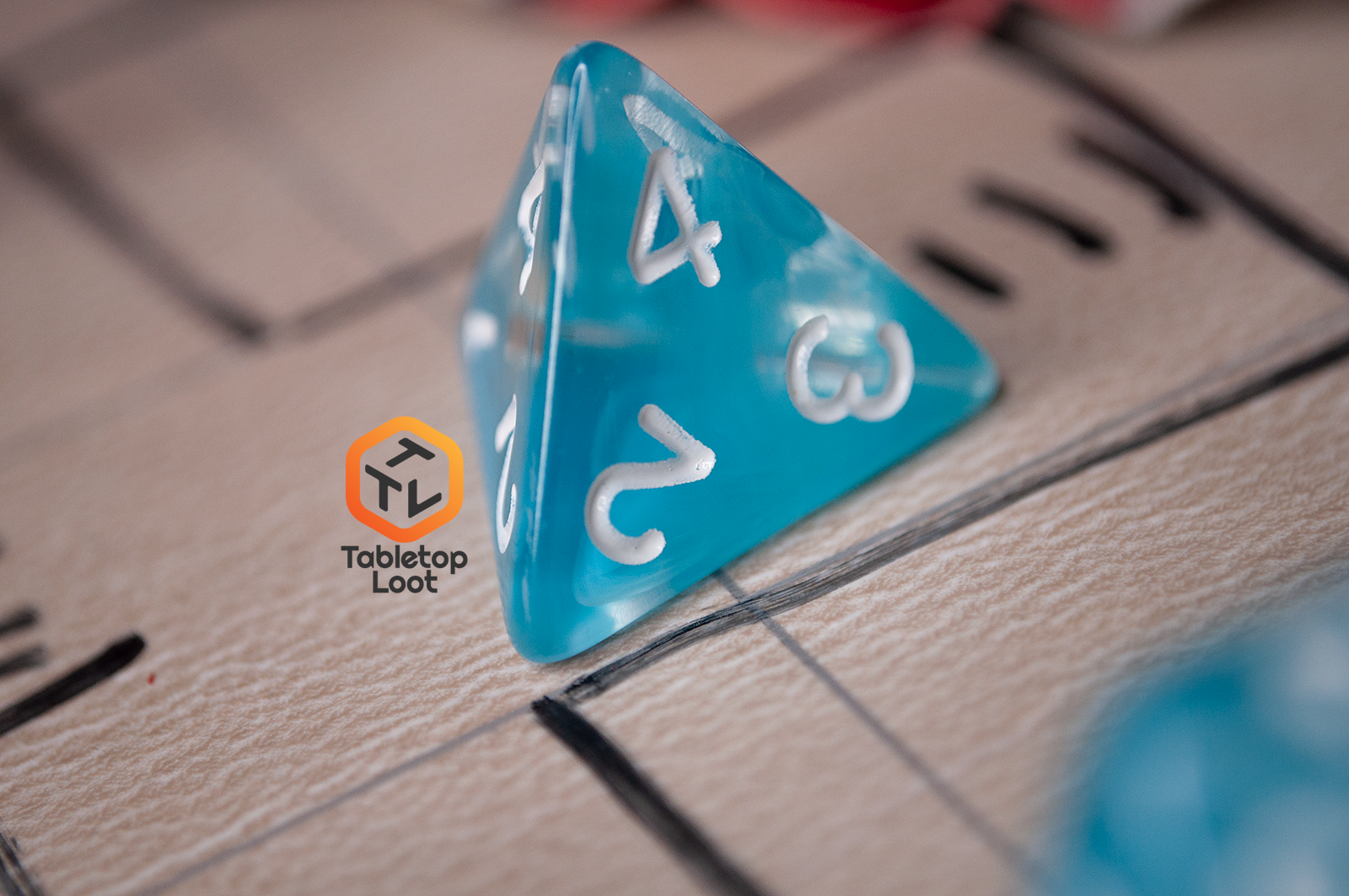 A close up of the D4 from the Sky Blue 7 piece dice set from Tabletop Loot with blue and white swirls in clear resin and white numbering.