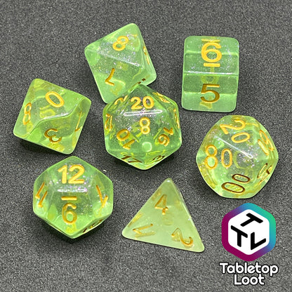 The Sprites 7 piece dice set from Tabletop Loot with light green translucent pigment packed with glitter and gold numbering.