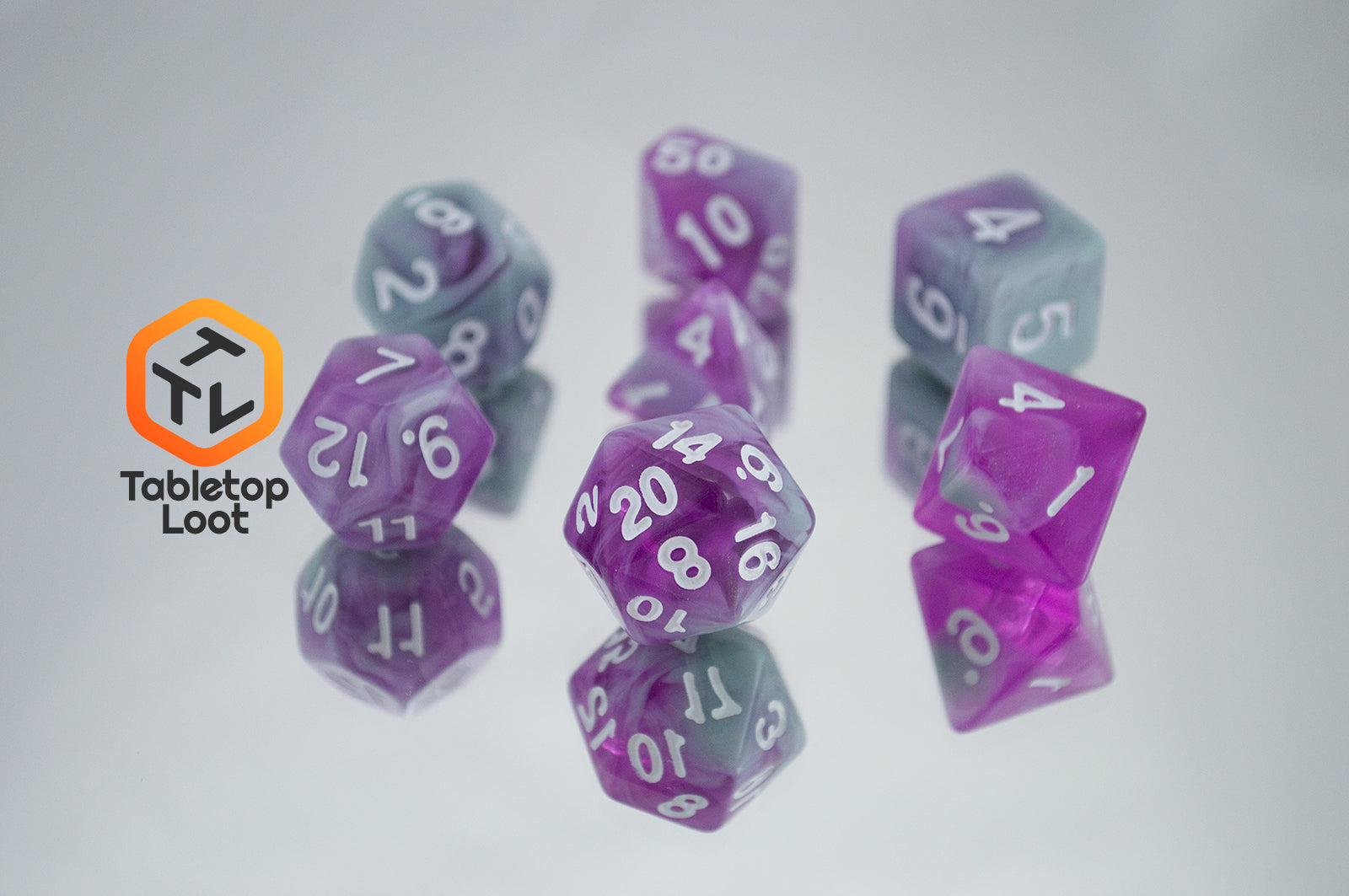 The Stars Shine 7 piece dice set from Tabletop Loot with purple and grey shimmering swirls and white numbering.