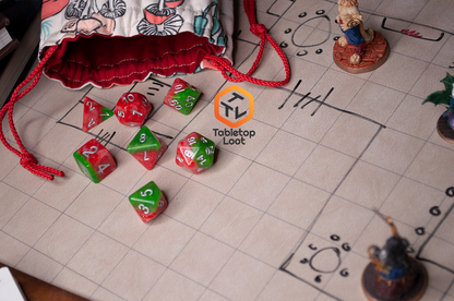 The Strawberry Fields 7 piece dice set with sparkling layers of red and green and silver numbering.