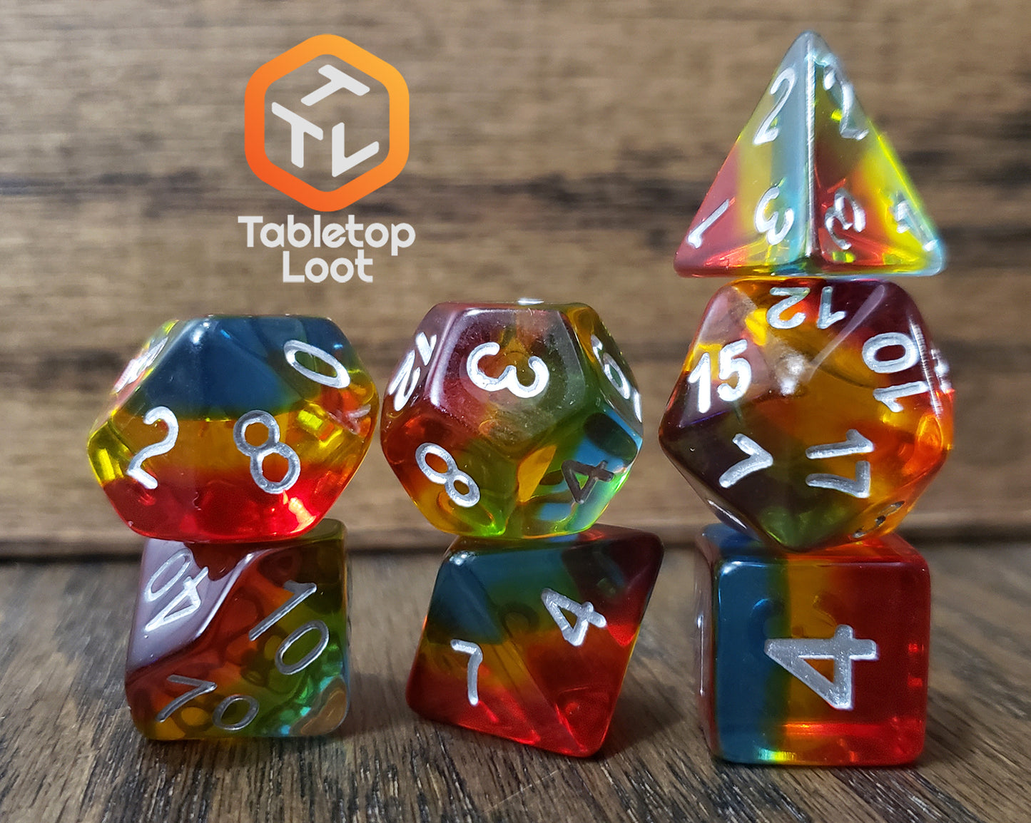 The Dusk 7 piece dice set from Tabletop Loot with blue, yellow, and red layers and white numbering.