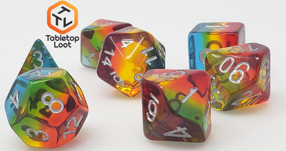 A close up of the Dusk 7 piece dice set from Tabletop Loot with blue, yellow, and red layers and white numbering.