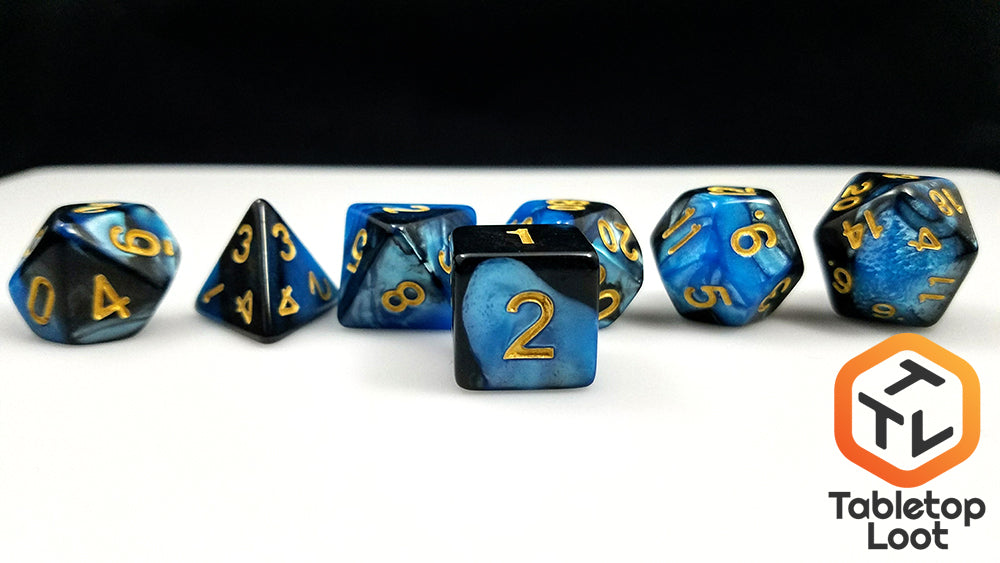 A close up of the D6 from the Blue Drake 7 piece dice set from Tabletop Loot with blue and black pearlescent resin swirls and gold numbering.