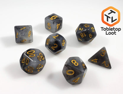 The Crystallized Smoke 7 piece dice set from Tabletop Loot with swirls of black and grey resin and gold numbers.