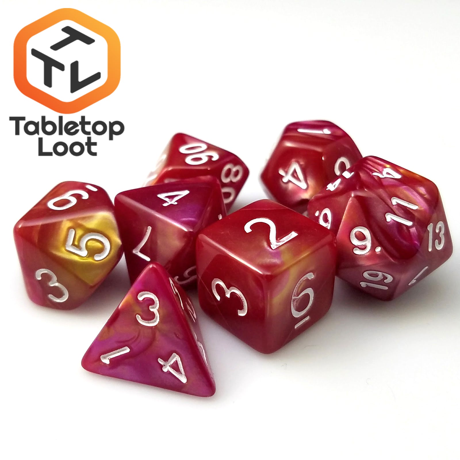 The Fire Opal 7 piece dice set from Tabletop Loot with swirls of pearlescent red and yellow and white numbering.