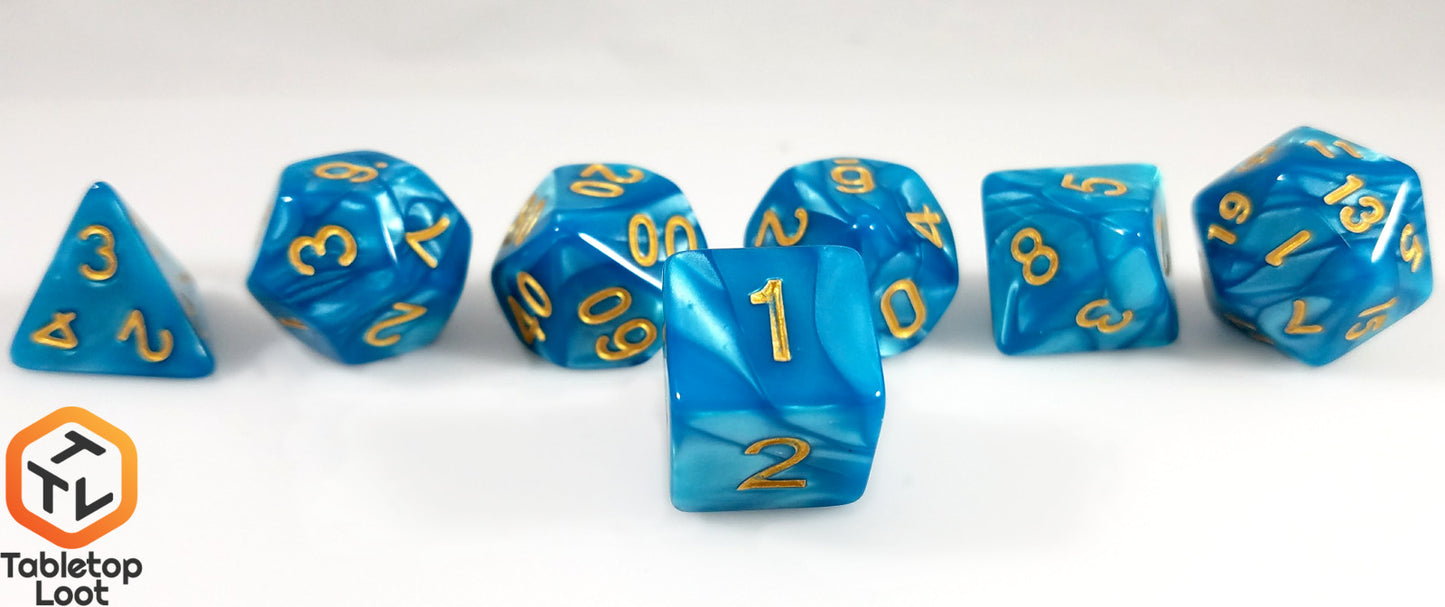 A close up of the D6 from the Gilded Turquoise 7 piece dice set from Tabletop Loot with swirls of turquoise resin and gold numbering.
