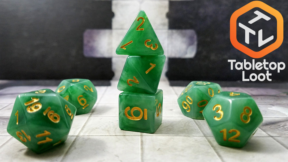 The Jade 7 piece dice set from Tabletop Loot with swirls of jade green and white resin and gold numbering.