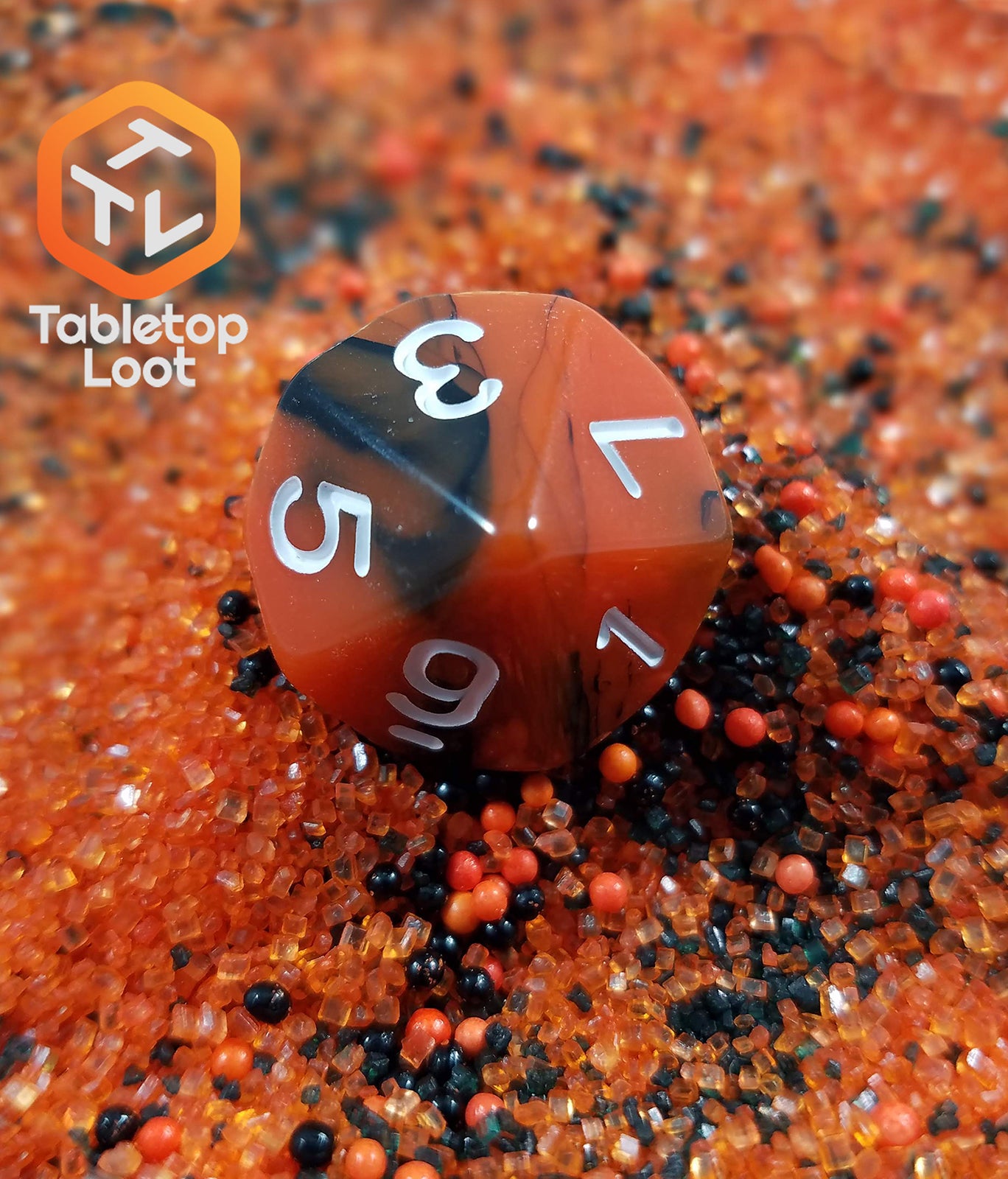 A close up of the D10 from the Lava Flow 7 piece dice set from Tabletop Loot with swirls of black and orange resin and white numbering.