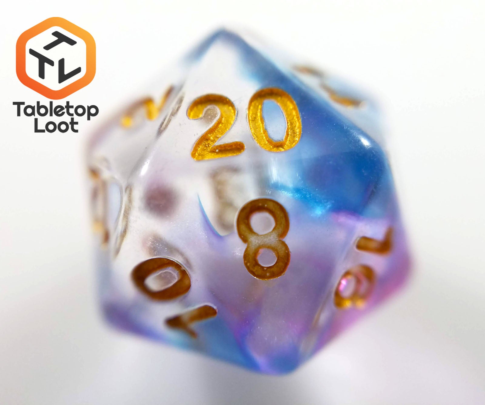 A close up of the D20 from the Misty Step 7 piece dice set from Tabletop Loot with swirls of purple and blue in clear resin with gold numbers.