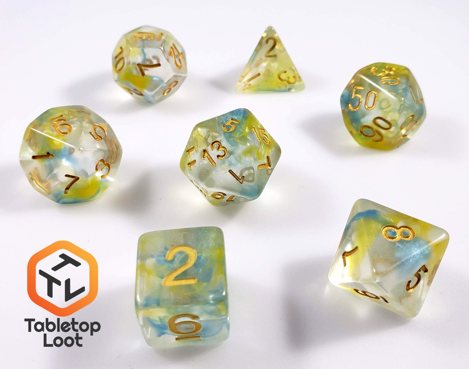 The Nature's Essence 7 piece dice set from Tabletop Loot with swirls of blue and green in clear resin with gold numbering.