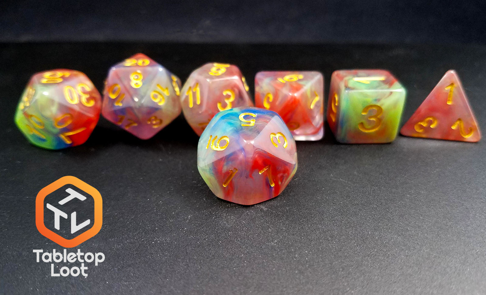 The Soul Stone 7 piece dice set from Tabletop Loot with swirls of blue, red, green, purple, and gold resin and gold numbering.