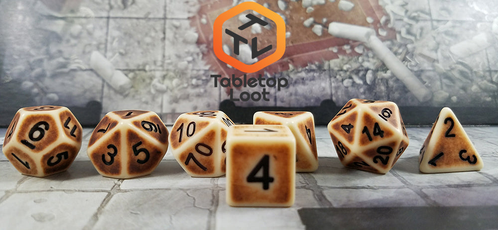 A close up of the D6 from the Dragon Bone 7 piece dice set from Tabletop Loot with a matte finish, brown aged sides, and black numbering.