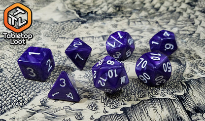 The Grape Jam 7 piece dice set from Tabletop Loot; swirled pearlescent purple dice with white numbering.