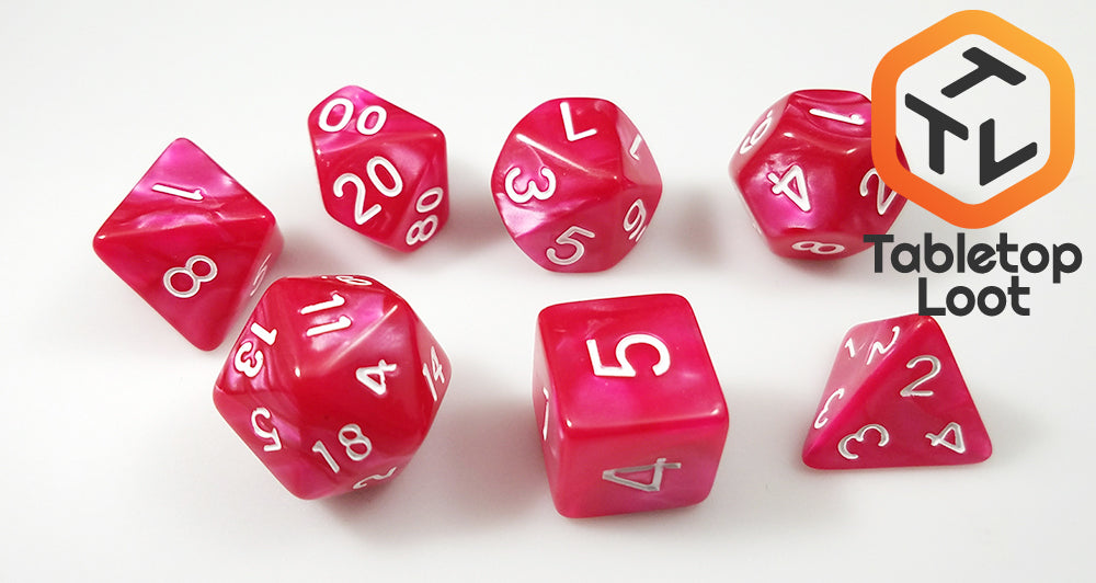 The Raspberry Tart 7 piece dice set with swirls of pearlescent pink and white numbering.