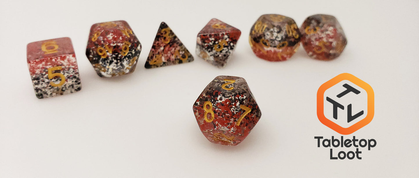 The Contagion 7 piece dice set from Tabletop Loot with black and red speckles suspended in clear and gold numbering.