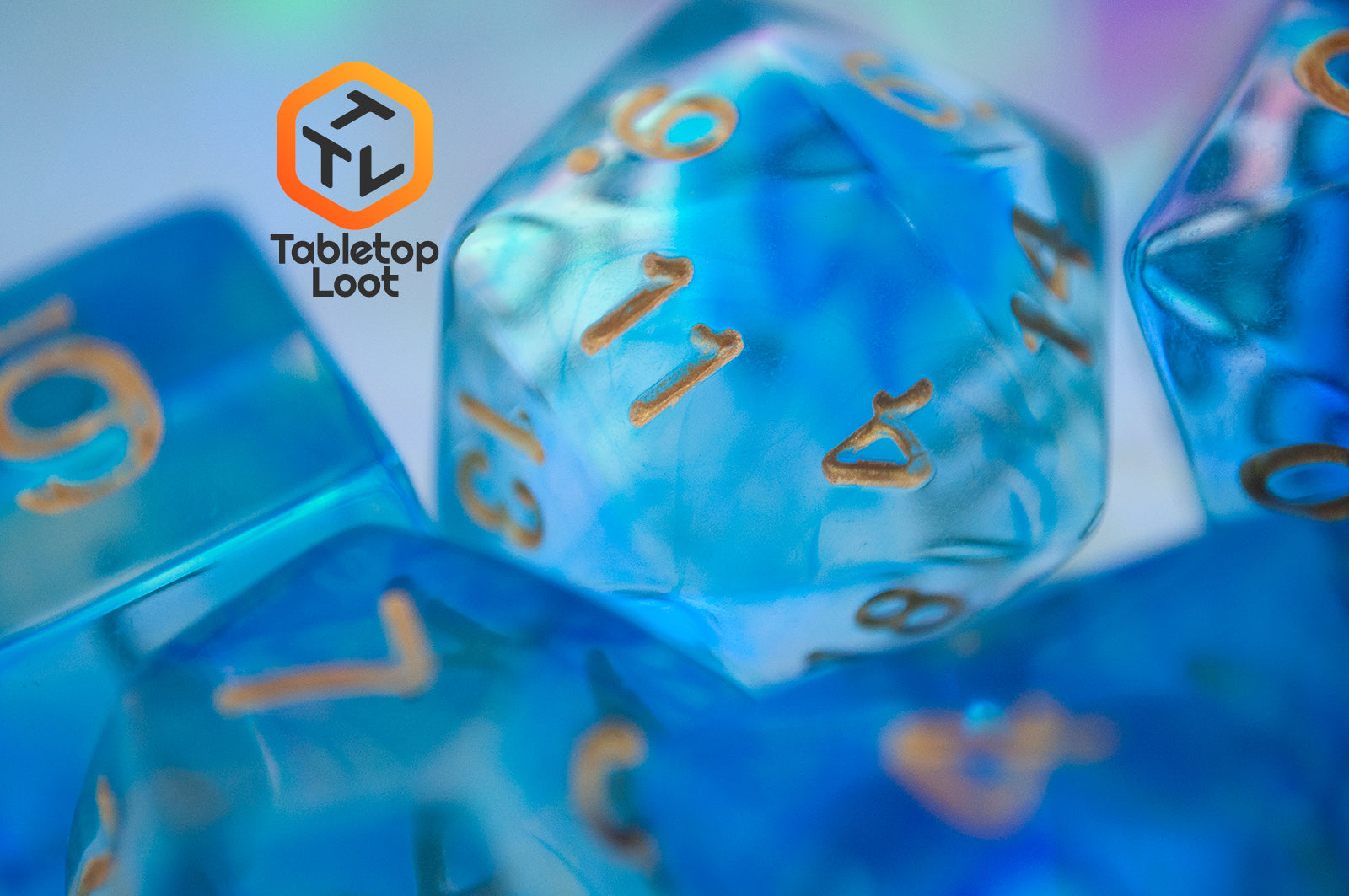 A close up of the D20 from the Under the Sea 7 piece dice set from Tabletop Loot with swirls of blue and gold numbering.