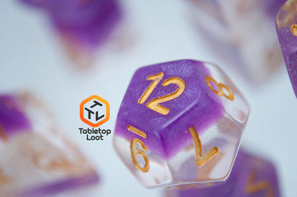 A close up of the D12 from the Gravitational Force 7 piece dice set from Tabletop Loot with a layer of light purple and clear glittery resin.