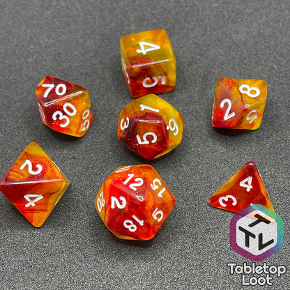 The I Have Walked Though Fire 7 piece dice set from Tabletop Loot with swirls of red in yellow that resemble flames and white numbering.