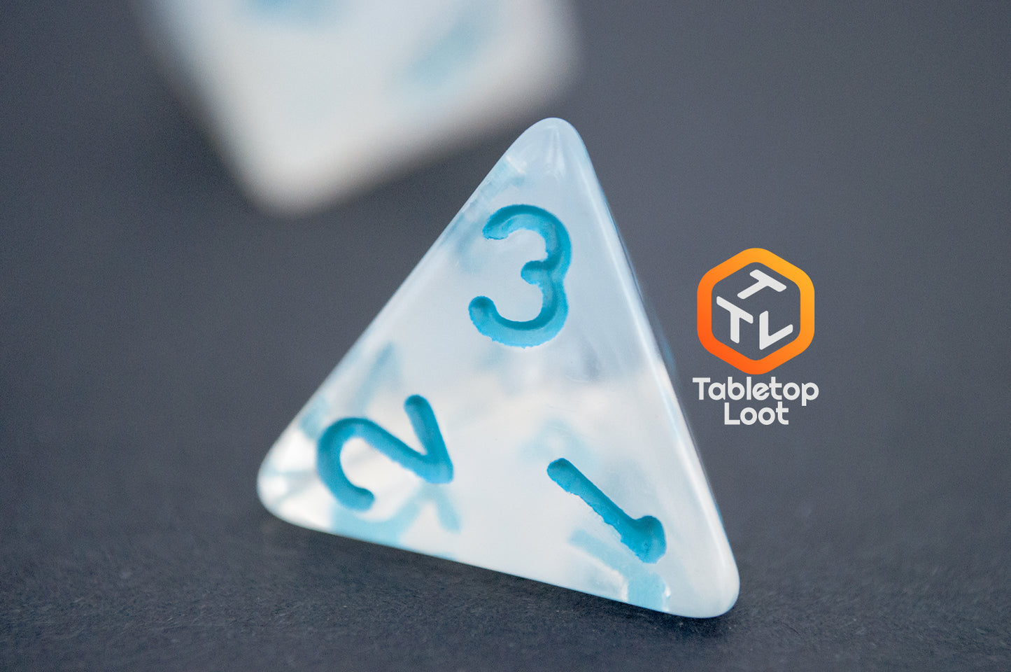 A close up of the D4 from the Dinneshere 7 piece dice set from Tabletop Loot with wispy white swirls and blue numbering.