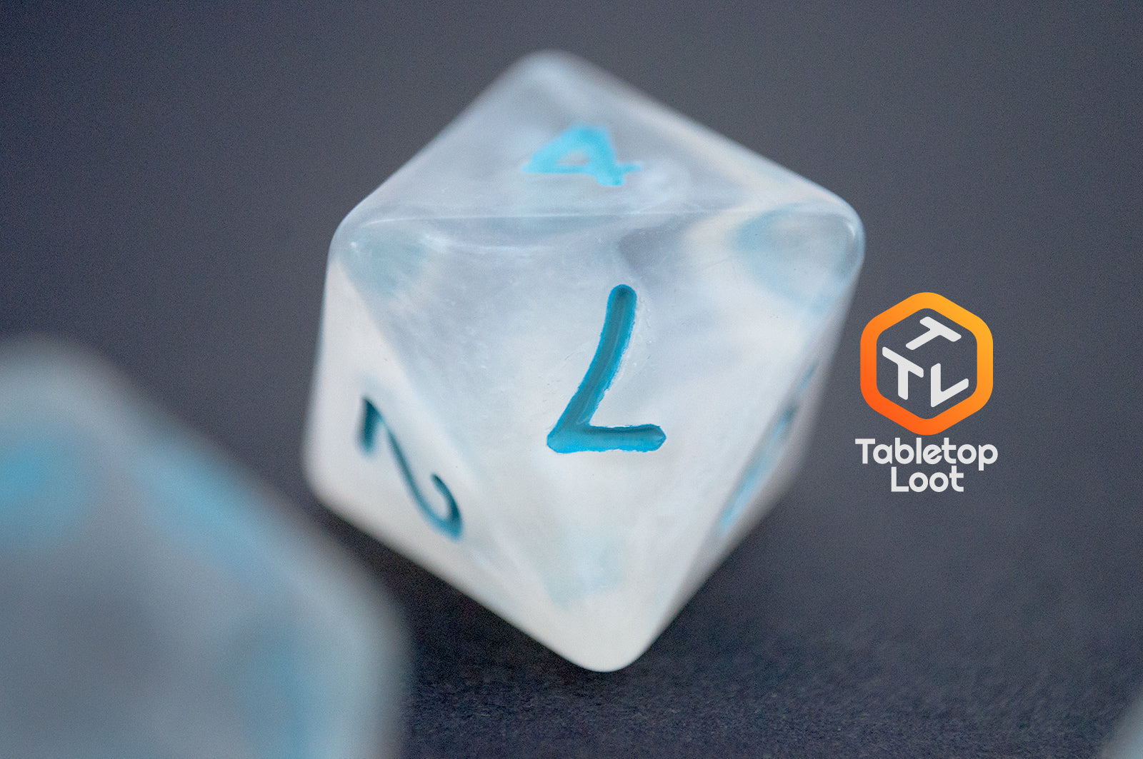 A close up of the D8 from the Dinneshere 7 piece dice set from Tabletop Loot with wispy white swirls and blue numbering.