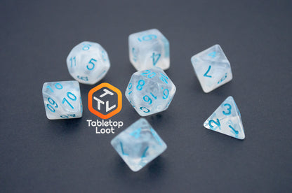 The Dinneshere 7 piece dice set from Tabletop Loot with wispy white swirls and blue numbering.