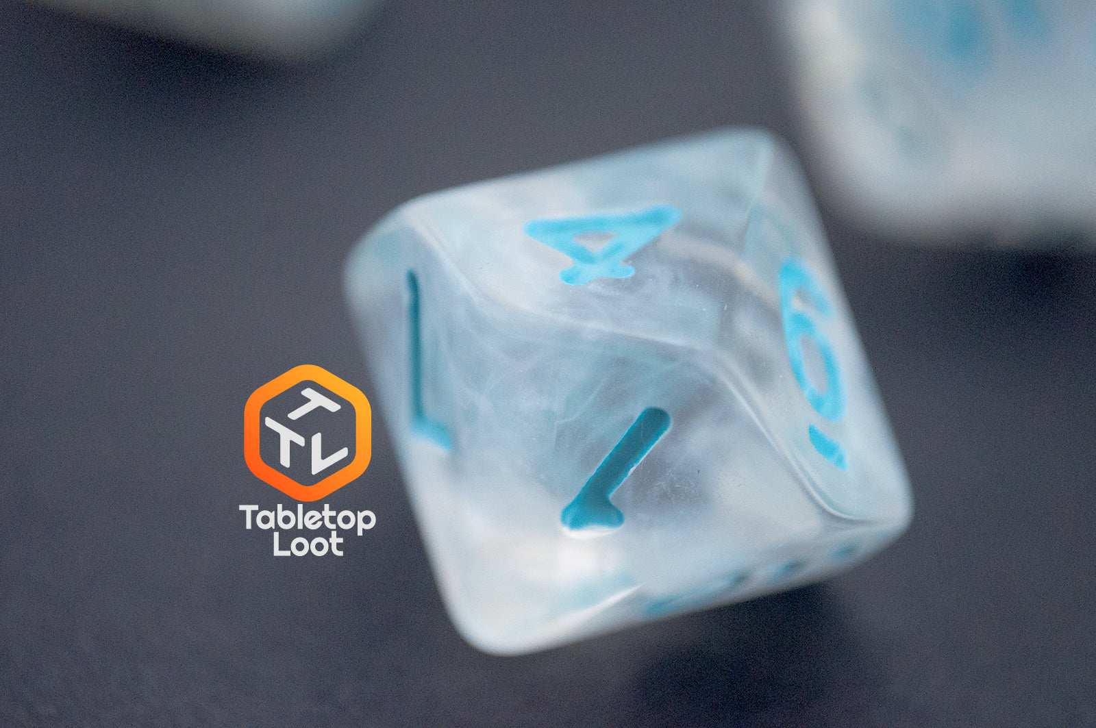 A close up of the D10 from the Dinneshere 7 piece dice set from Tabletop Loot with wispy white swirls and blue numbering.