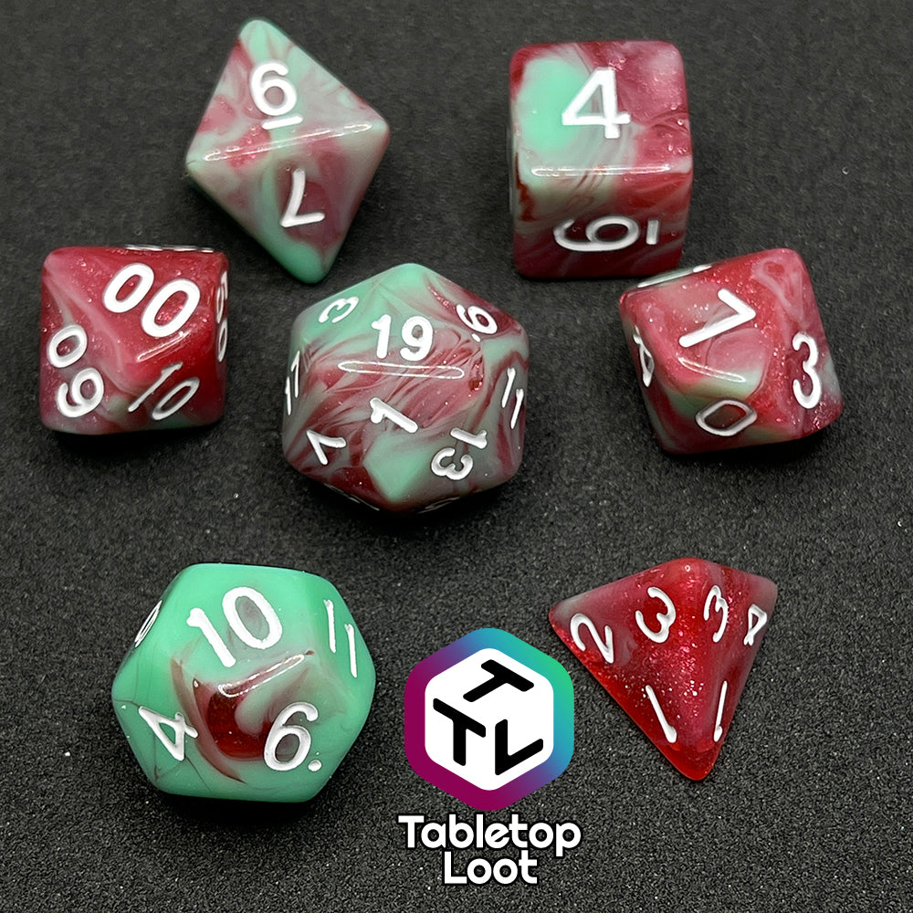 The Zombies 7 piece dice set from Tabletop Loot with sickly green and glittering red swirls and white numbering.