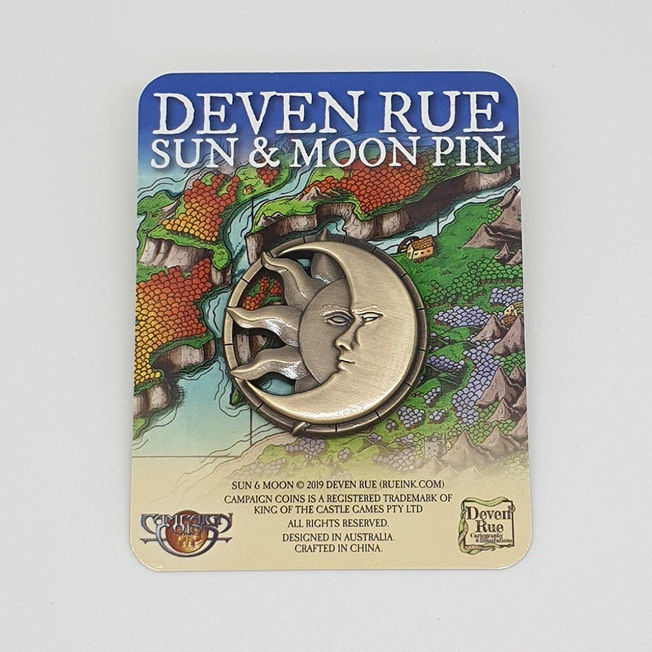 The Sun and Moon pin by Deven Rue with a cutout design of a sun and moon in the same circle, details carved into the relief.