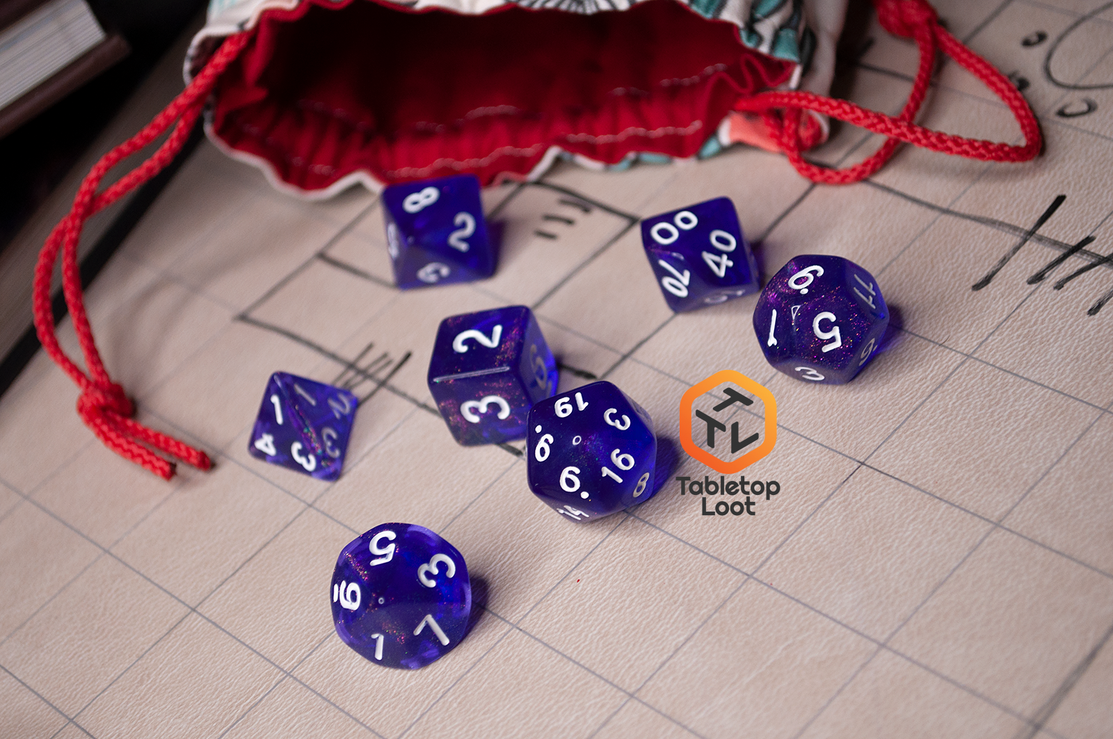 The Diamond Purple 7 piece dice set from Tabletop Loot with purple dice filled with micro glitter and white numbering.